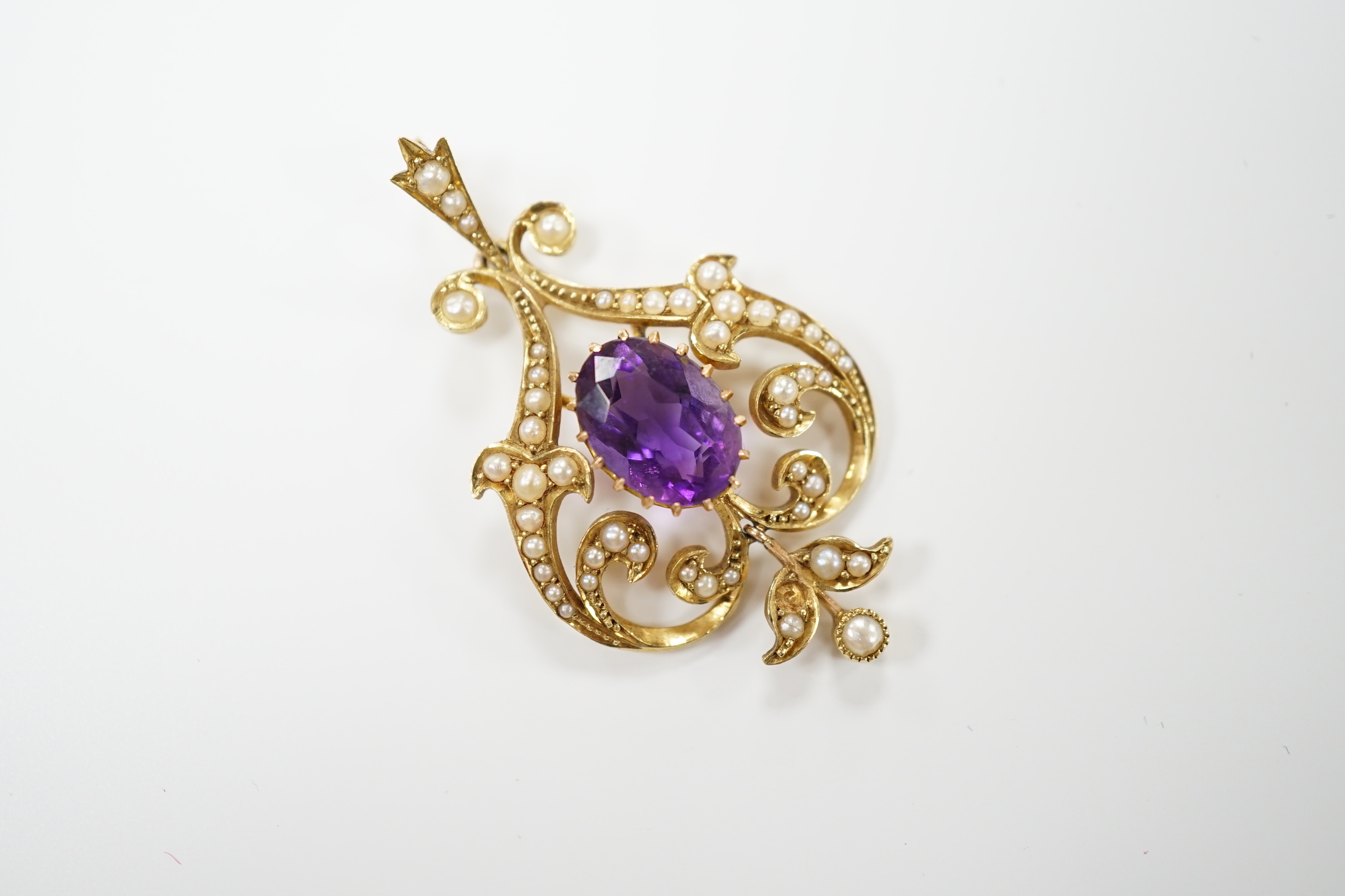 An Edwardian 15ct, amethyst and split pearl cluster set pendant, 40mm, gross weight 4.6 grams.